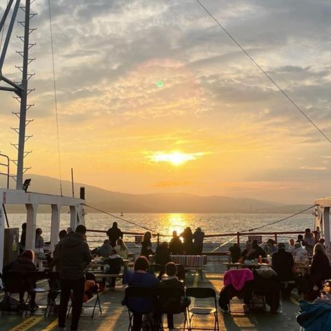 a group of people walking through a cloudy sky