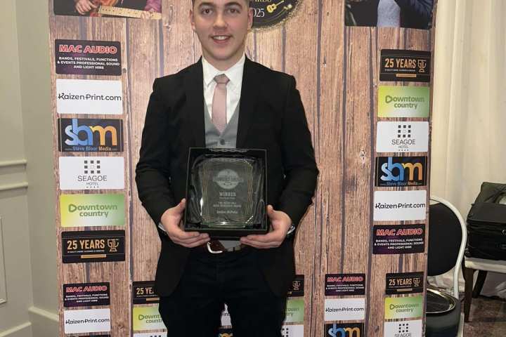 a person holding a sign posing for the camera