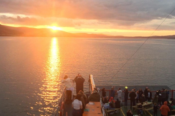 a group of people in a boat on a body of water